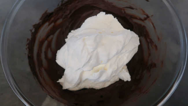 Folding whipped cream into chocolate