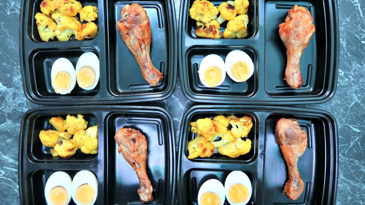 Keto meal prep boxes with chicken, hard boiled egg and cauliflower