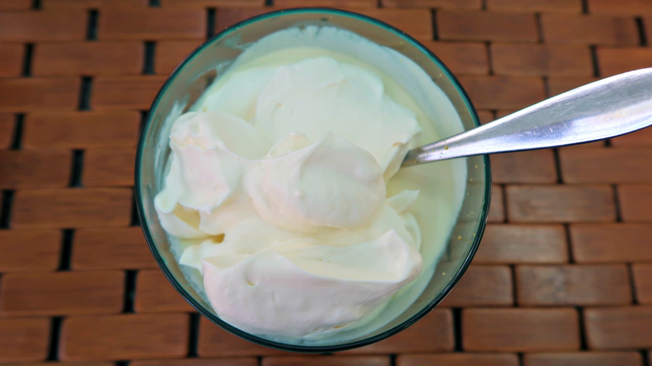 Bowl of whipped cream with the lemon mixture 