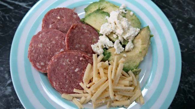 Keto breakfast without eggs platter of salami, avocado, feta and grated cheese