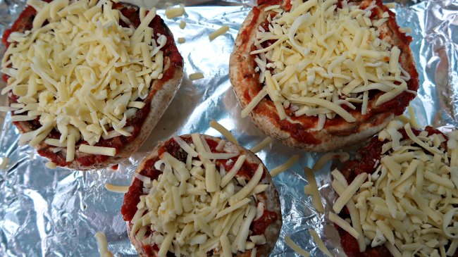 4 Pizza Stuffed Mushrooms on a baking tray