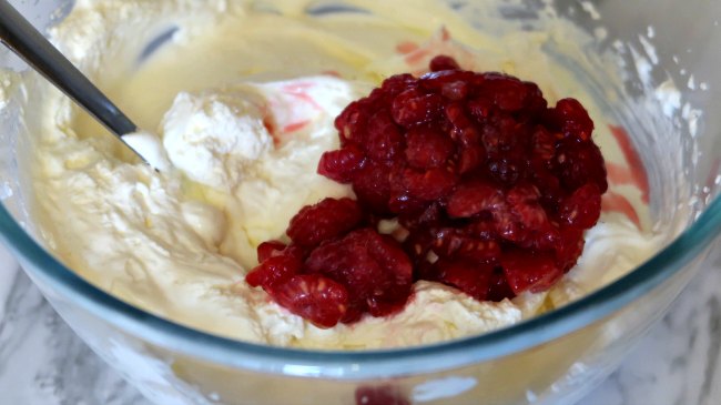 Mixing raspberries into the creamy low carb dessert