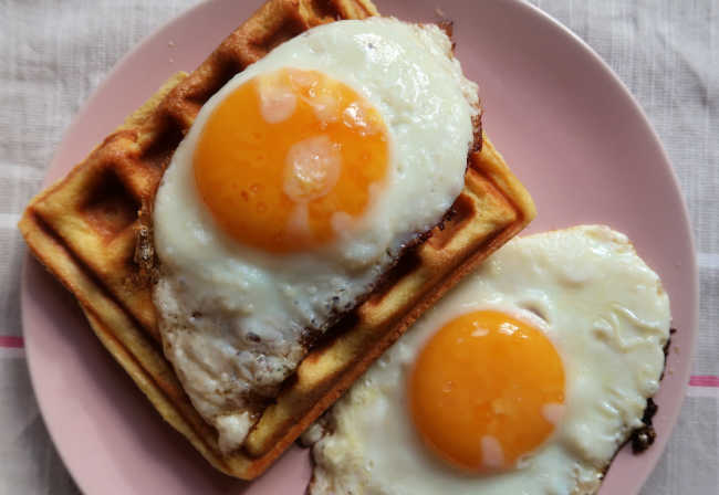 Waffles topped with eggs