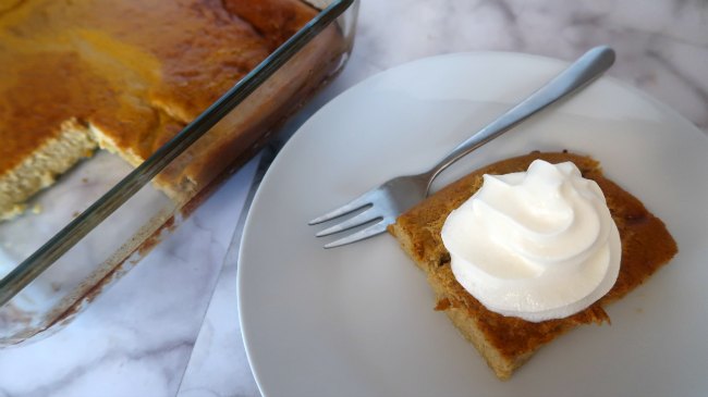 Low carb pumpkin pie on a plate topped with whipped cream