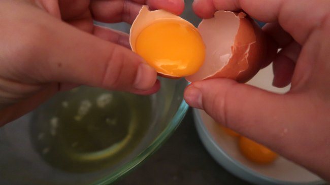 Passing egg yolk between shells
