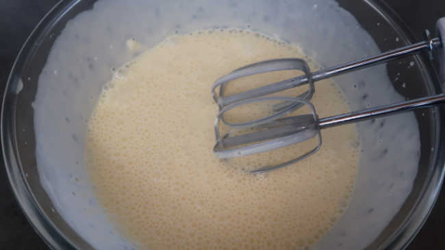 Whisking ingredients together for Goat Cheese Cheesecake