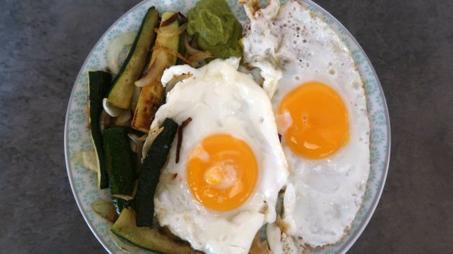 Breakfast plate with fried eggs and vegetables