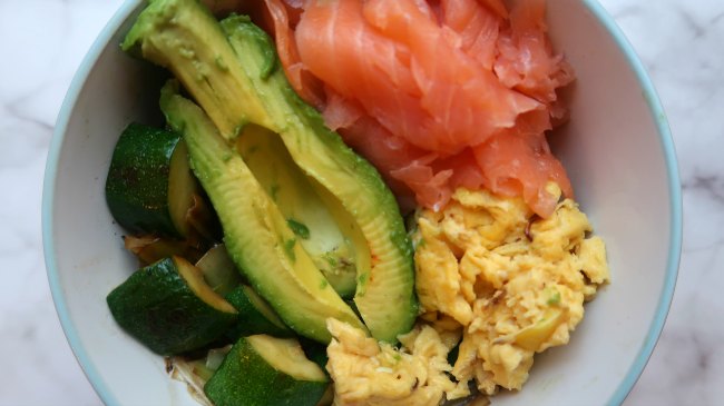 Low carb keto breakfast bowl with vegetables, avocado, smoked salmon and scrambled eggs