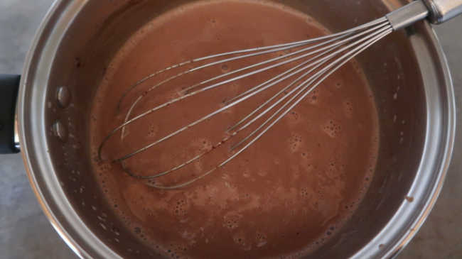 Whisking ingredients together for chocolate panna cotta recipe