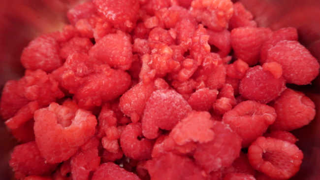 Saucepan with frozen raspberries