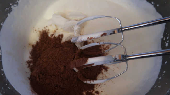 Adding cocoa powder, sugar and cream cheese