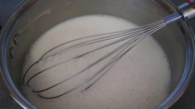 Coconut milk panna cotta mixture in a small saucepan or pot