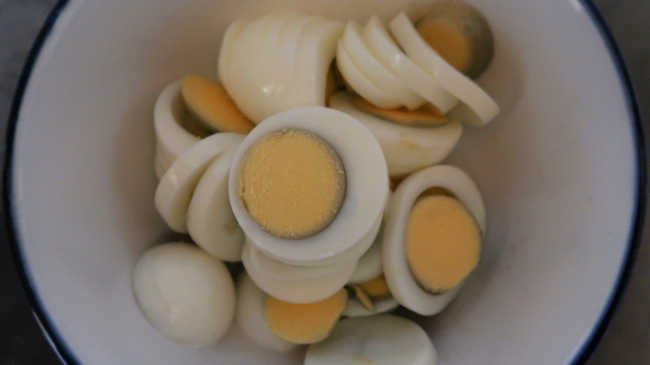 Bowl of sliced hard boiled eggs