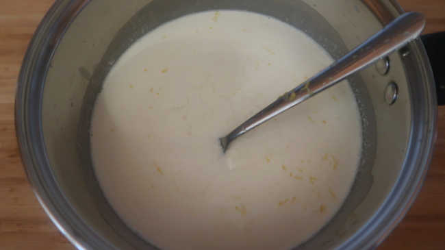 Mixing lemon zest and juice into lemon panna cotta