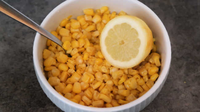 Bowl with lemon and frozen corn