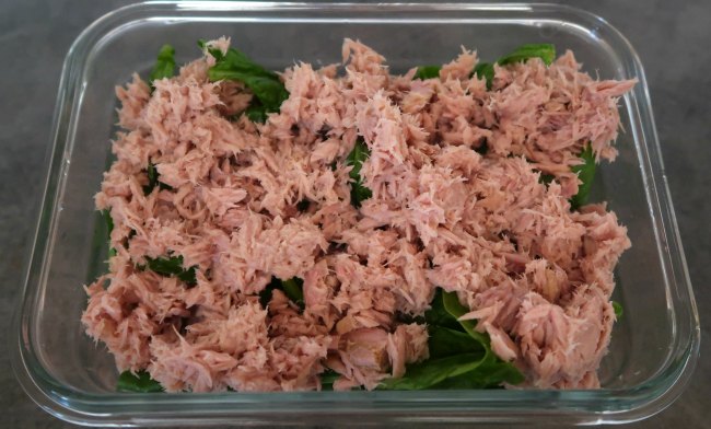 Meal prep container with spinach and tuna