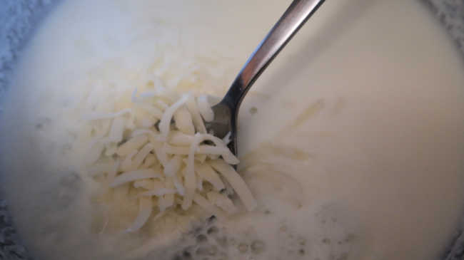 Mixing through the grated cheese