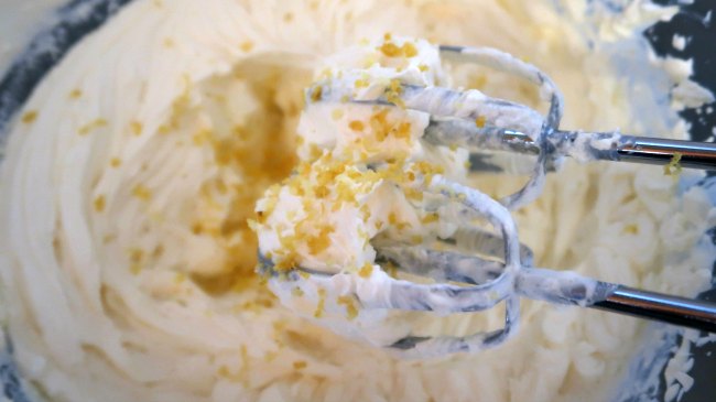 Whisking lemon zest into the whipped cream