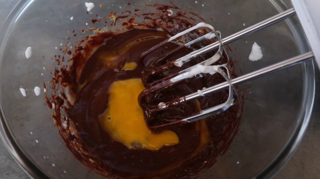 Whisking the egg yolks into chocolate