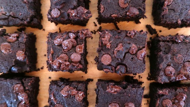 Top 10 Chocolate Desserts - gooey brownies with cocoa powder and chocolate chips