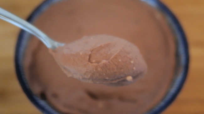 Spoon of coconut milk chocolate mousse