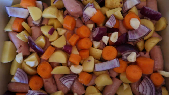 Mixing all of the vegetables and sausages together