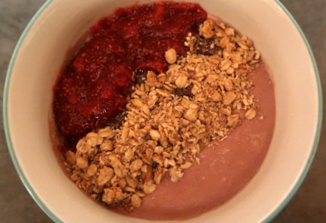 Chocolate overnight oats recipe topped with granola and jam