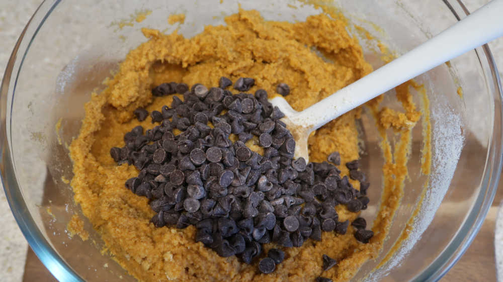 Adding chocolate chips to the pumpkin bread batter