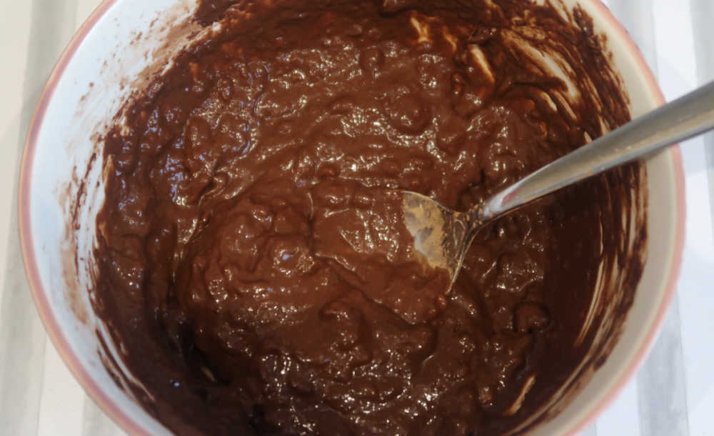 Mixing mashed banana and cocoa powder together
