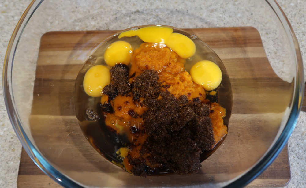 Mixing together the umpkin puree, eggs, brown sugar, melted butter and vanilla extract
