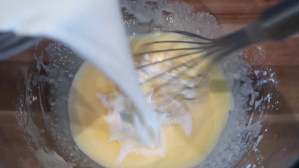 Pouring the warmed milk over the rest of the ingredients