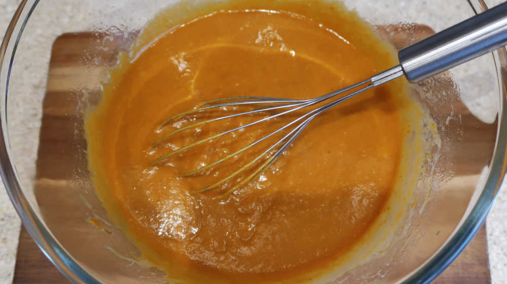 Whisking together the pumpkin puree to form the pumpkin chocolate chip bread batter